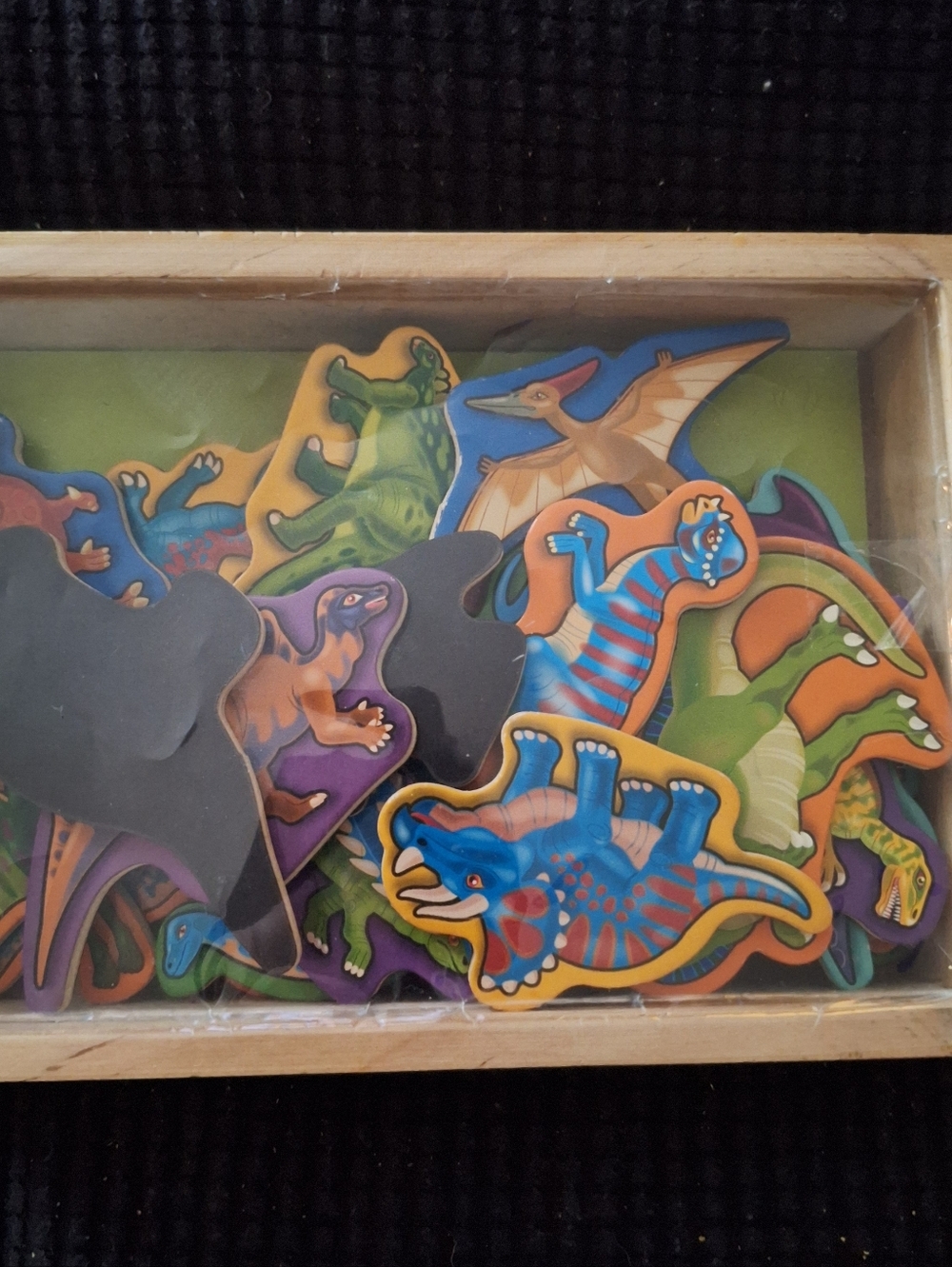 The Melissa & Doug Magnetic Wooden Dinosaurs set includes 20 colorful dinosaur